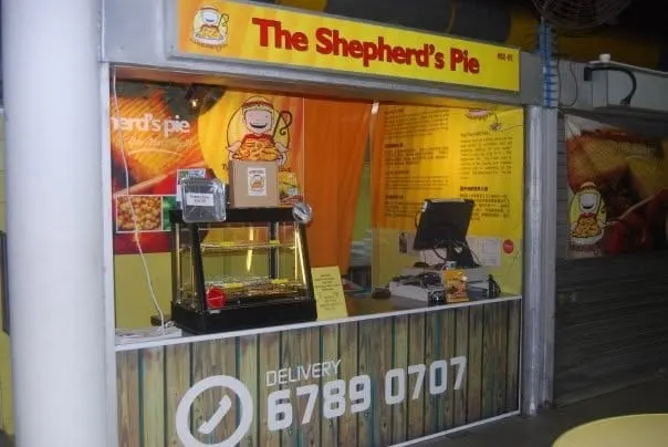 The Shepherd’s Pie stall in Simpang Bedok, with a pie warmer on the counter and “Delivery 6789 0707” across the front